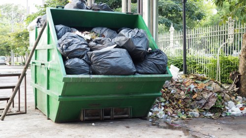 Low-emission skip hire van parked on a London street near recycling bins